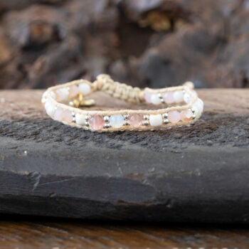 Coastal Coral Healing Stones Bracelet by Lotus & Luna on a rustic piece of wood and against rustic wood backdrop