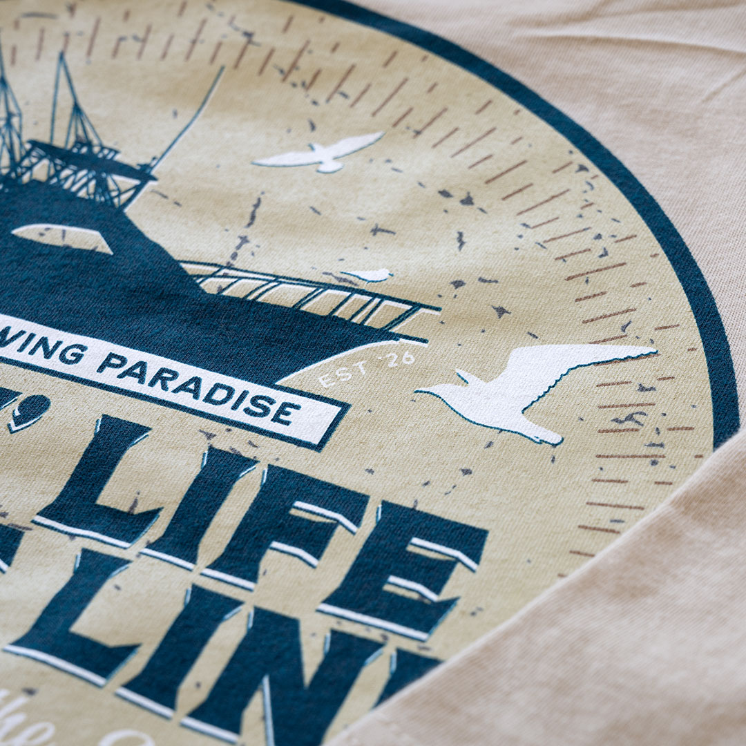 Top closeup view of the back graphic on the Livin' Life on the Line tee in the color cream by Porch Swing Paradise