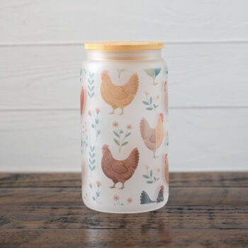 Emma K Designs Colorful Chicken glass tumbler on a rustic wood table with white rustic wood backdrop