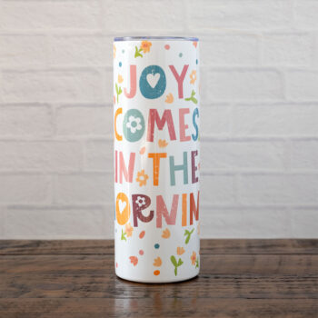 Joy Comes in the Morning stainless skinny tumbler against rustic wood backdrop