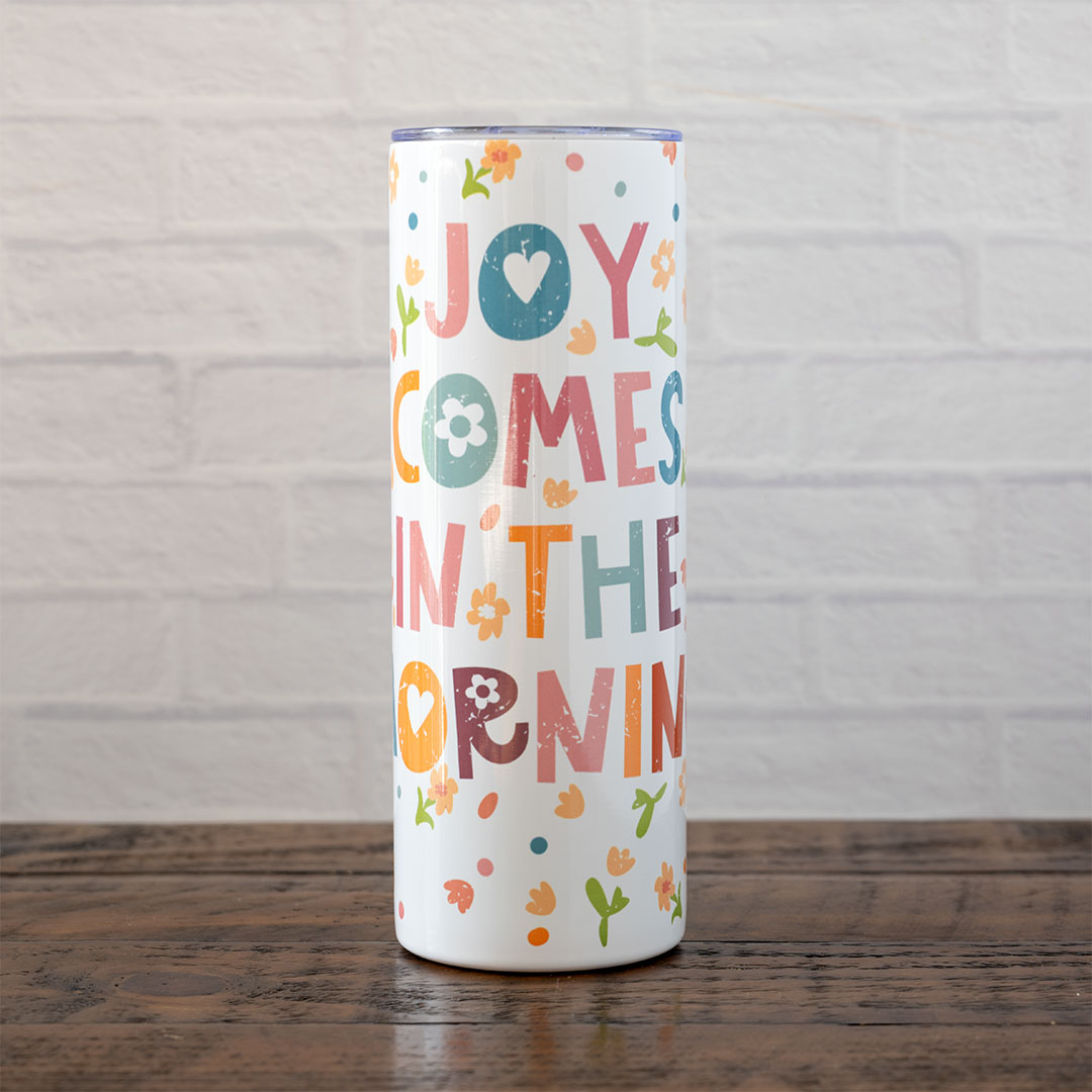 Joy Comes in the Morning stainless skinny tumbler against rustic wood backdrop