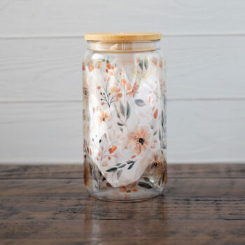 The Emma K Designs The Meadows glass tumbler against a rustic wooden backdrop