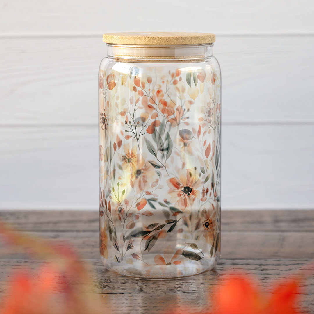 Back view of the Emma K Designs The Meadows glass tumbler in front of greenery and against a rustic wooden backdrop